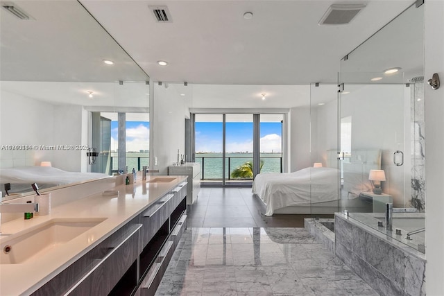 bathroom featuring a water view, vanity, and plus walk in shower