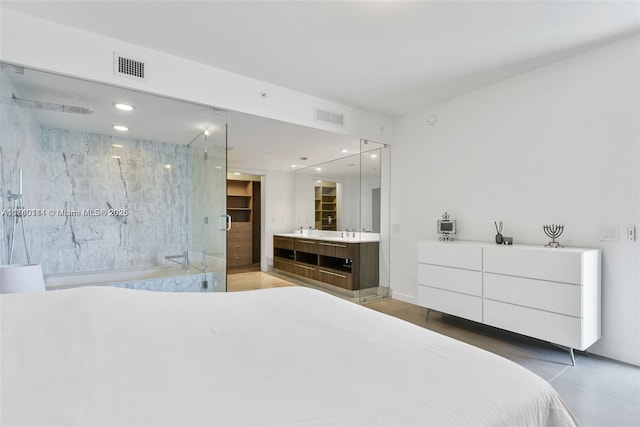 bedroom with sink and connected bathroom