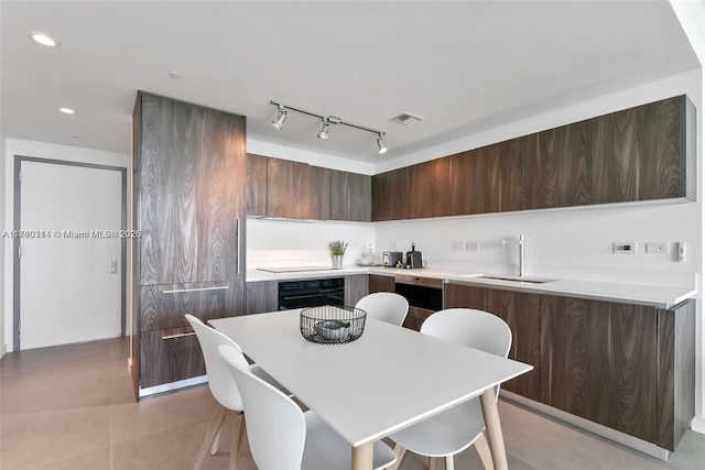 kitchen featuring sink, a breakfast bar area, oven, and dishwasher