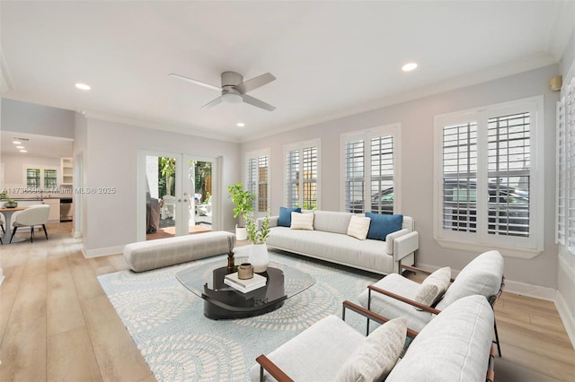 living room featuring light hardwood / wood-style flooring, ornamental molding, french doors, and ceiling fan