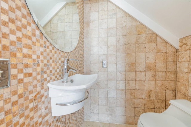 bathroom with lofted ceiling, tile walls, and toilet