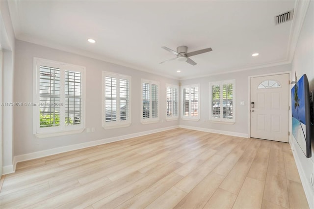 unfurnished living room with ceiling fan, ornamental molding, light hardwood / wood-style flooring, and a wealth of natural light