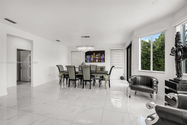 dining space featuring marble finish floor and visible vents