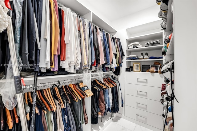 spacious closet featuring marble finish floor