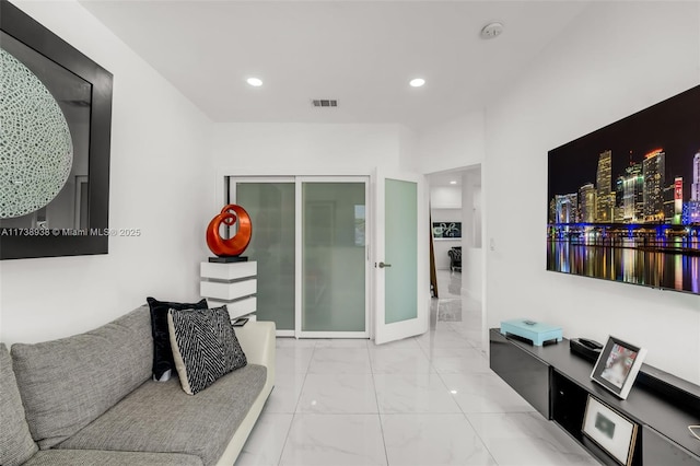 living area featuring marble finish floor, visible vents, french doors, and recessed lighting