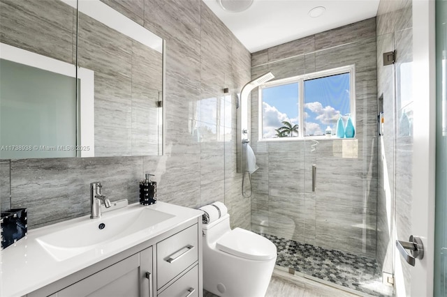 bathroom featuring toilet, vanity, tile walls, decorative backsplash, and a stall shower