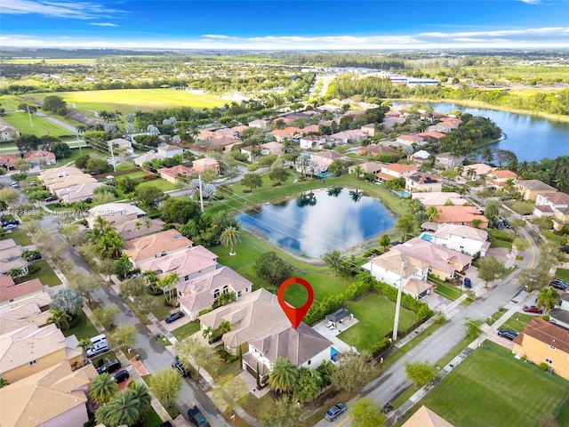 aerial view with a water view, a residential view, and golf course view