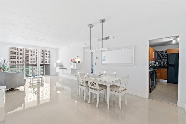 dining area with visible vents, baseboards, and light tile patterned flooring