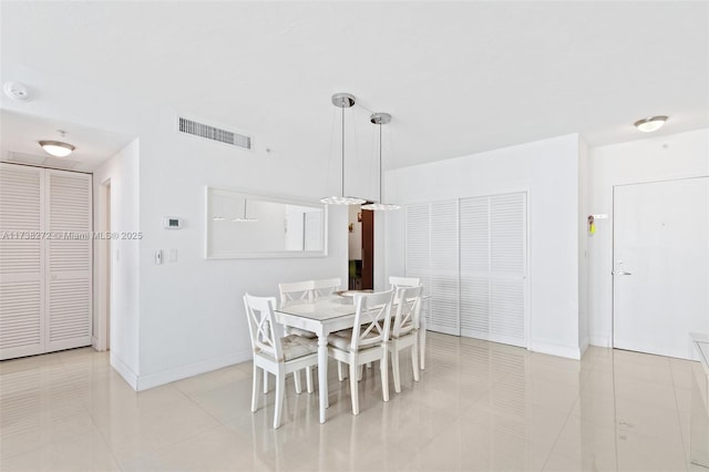 dining area featuring visible vents, baseboards, and light tile patterned floors