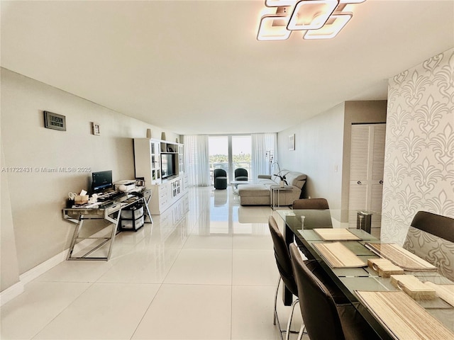 dining space featuring light tile patterned flooring and baseboards