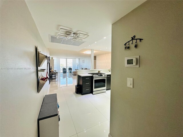 hall featuring light tile patterned floors