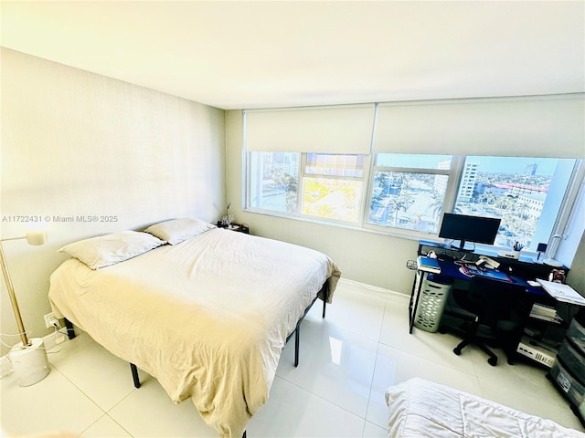 bedroom featuring multiple windows and light tile patterned floors