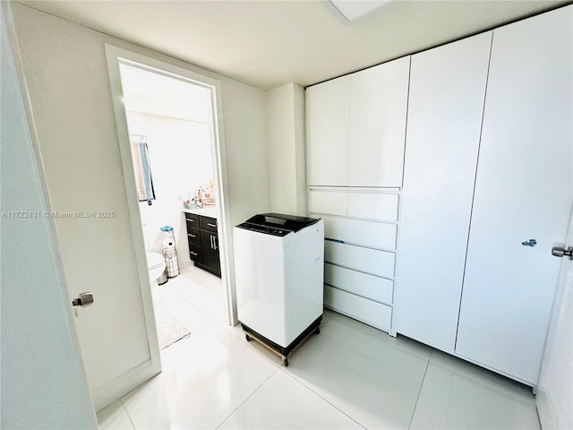 washroom featuring light tile patterned floors and laundry area