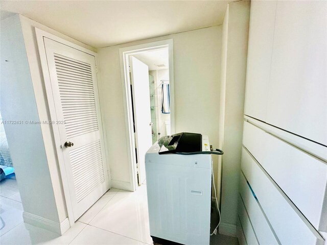 laundry area with light tile patterned flooring and washer / clothes dryer