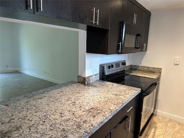 kitchen featuring electric stove, dark brown cabinets, light stone countertops, black microwave, and baseboards