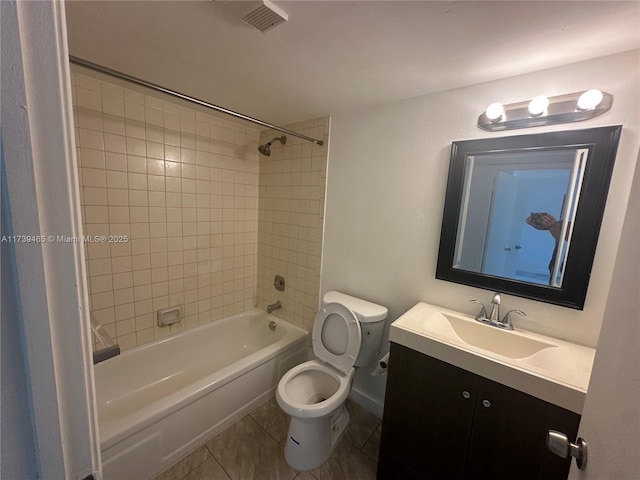 bathroom featuring bathtub / shower combination, toilet, visible vents, vanity, and tile patterned floors