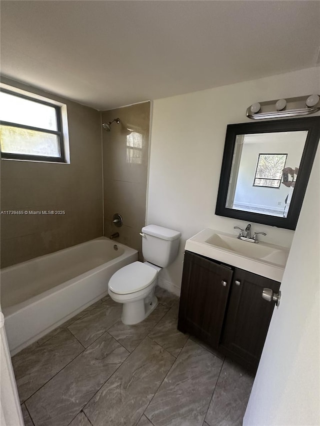 bathroom featuring marble finish floor, shower / bath combination, vanity, and toilet