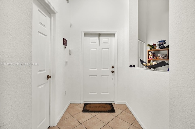 doorway with light tile patterned floors