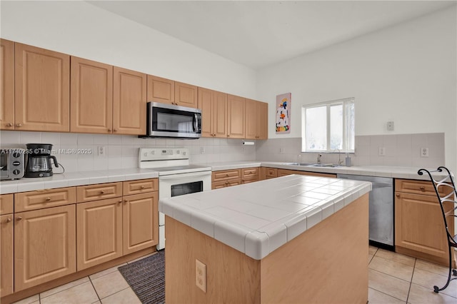 kitchen with light tile patterned flooring, tile countertops, a center island, stainless steel appliances, and decorative backsplash