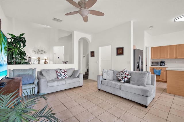 tiled living room featuring ceiling fan