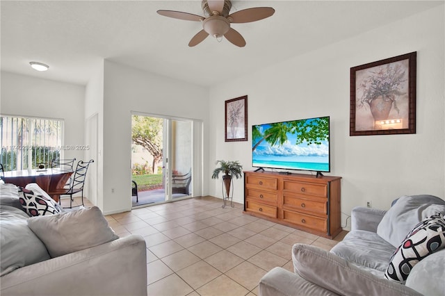 living room with a healthy amount of sunlight, light tile patterned floors, and ceiling fan