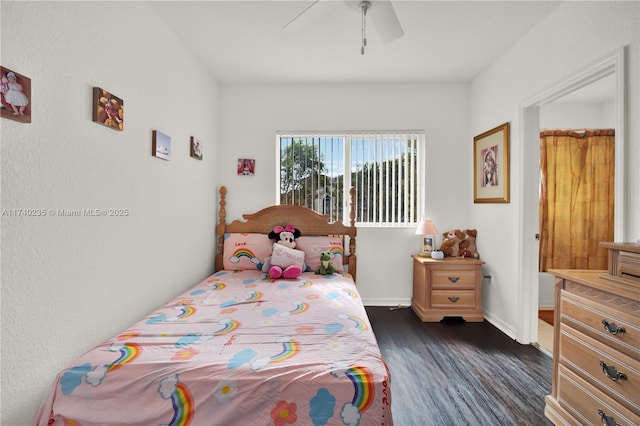 bedroom with dark hardwood / wood-style floors and ceiling fan