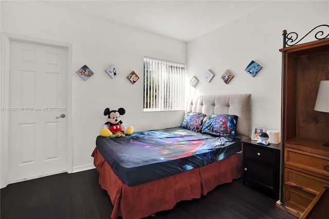 bedroom with dark wood-type flooring