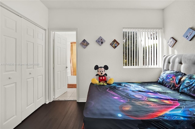 bedroom featuring dark hardwood / wood-style flooring and a closet