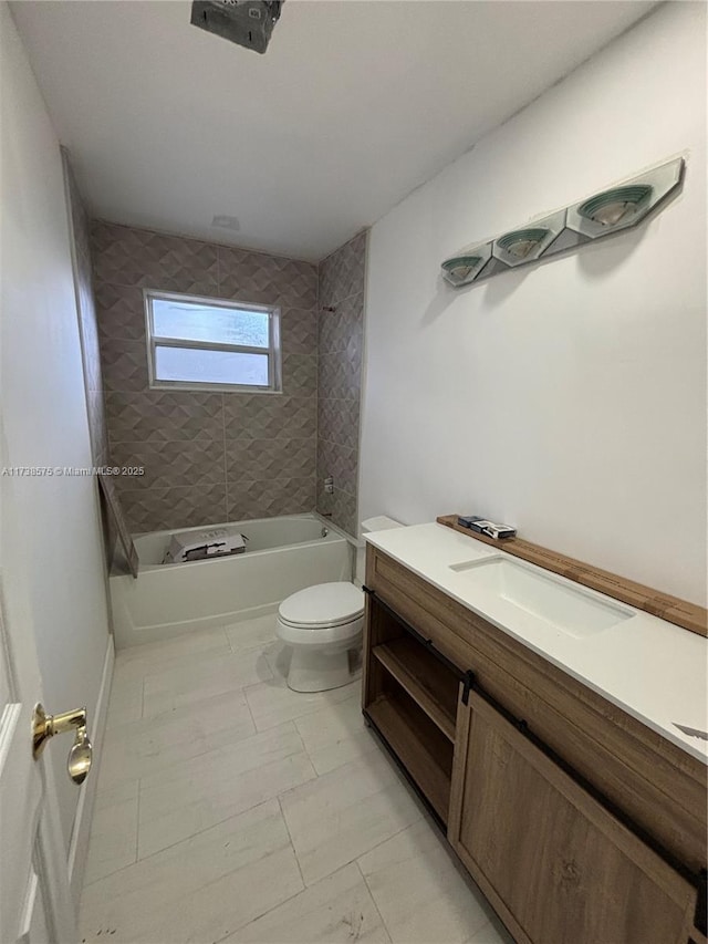 full bathroom with vanity, tiled shower / bath combo, and toilet