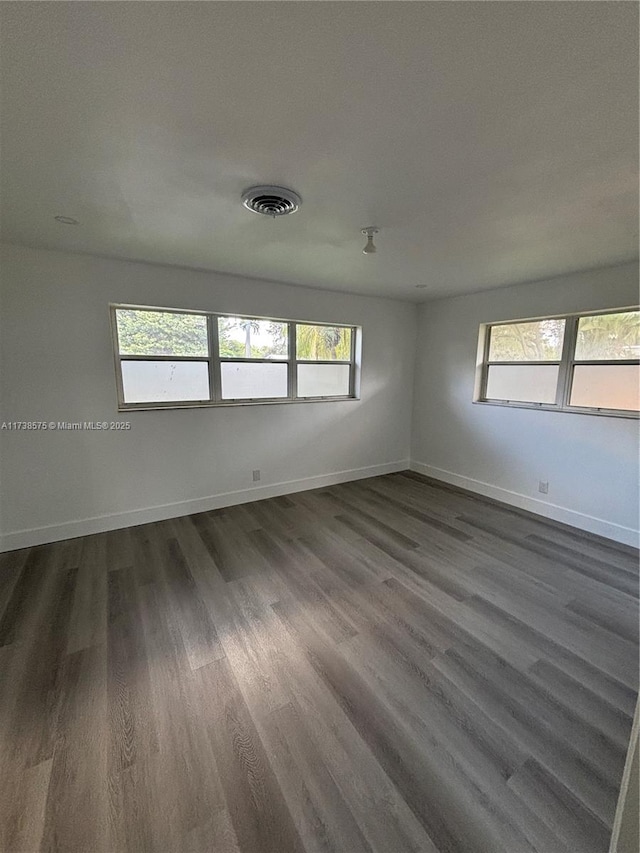 spare room featuring dark hardwood / wood-style flooring