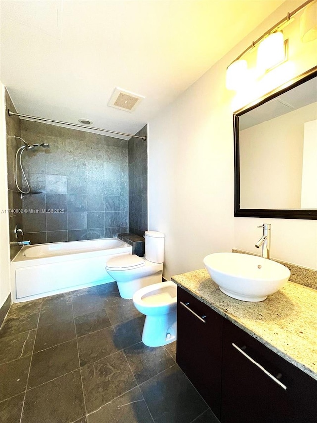 full bath with toilet, visible vents, vanity, tub / shower combination, and a bidet