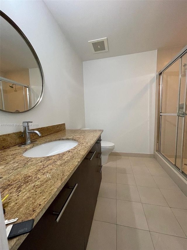 full bath featuring visible vents, a shower stall, vanity, tile patterned flooring, and baseboards