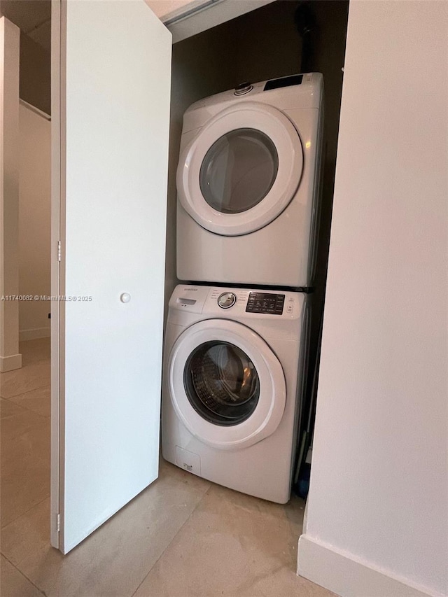 laundry area with laundry area and stacked washer / drying machine