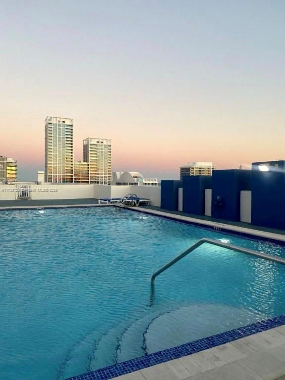 view of pool at dusk