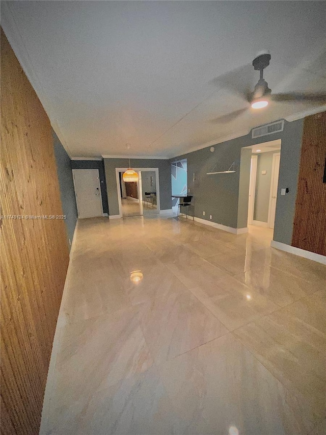 interior space with wooden walls and ceiling fan