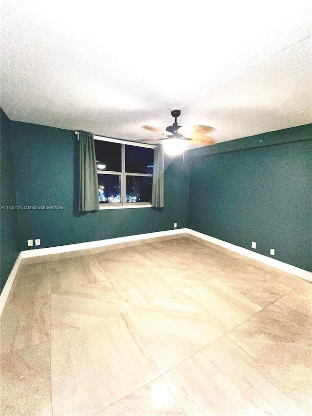 spare room featuring ceiling fan and a textured ceiling