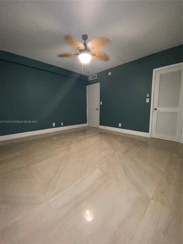 unfurnished room with ceiling fan