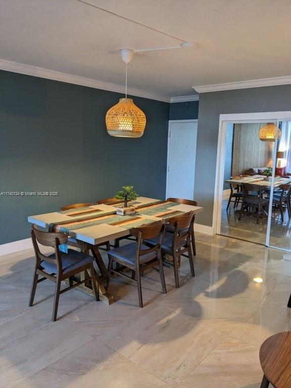 dining space with crown molding