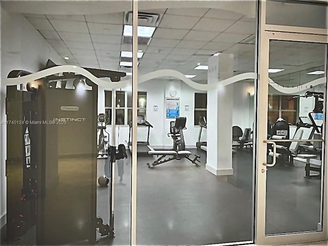 exercise room featuring a paneled ceiling