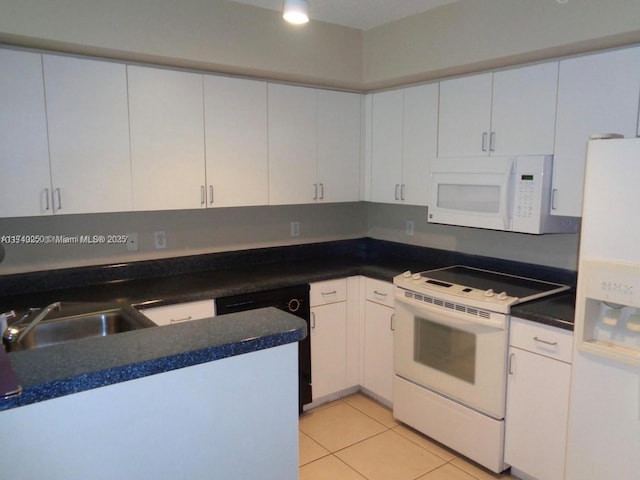 kitchen with white cabinetry, light tile patterned floors, white appliances, and sink