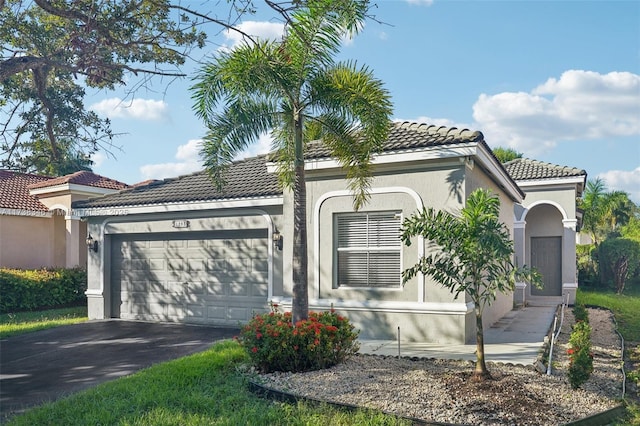 mediterranean / spanish home featuring a garage