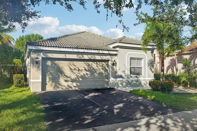 mediterranean / spanish-style home with a garage