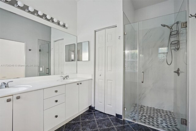 bathroom with vanity, an enclosed shower, and tile patterned flooring