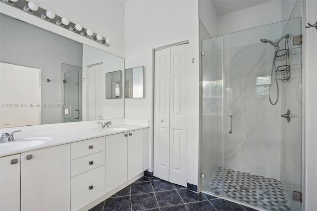 bathroom featuring vanity, tile patterned floors, and a shower with shower door