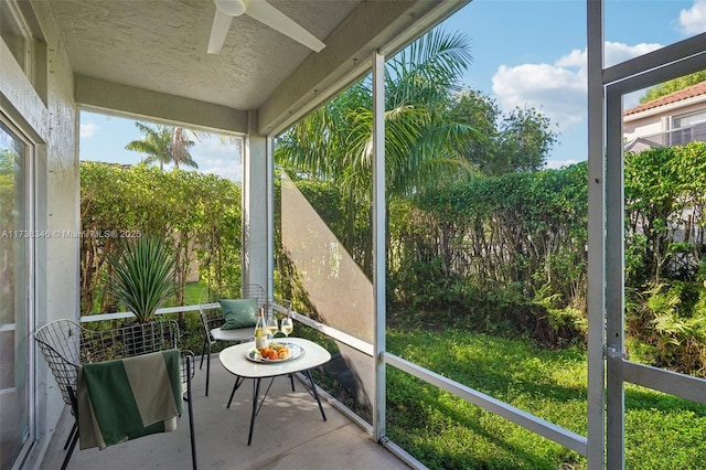 sunroom featuring ceiling fan