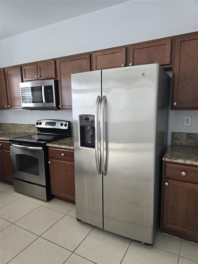 kitchen with stainless steel appliances and light tile patterned floors