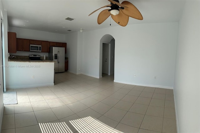 kitchen featuring stainless steel appliances, light tile patterned flooring, sink, and ceiling fan