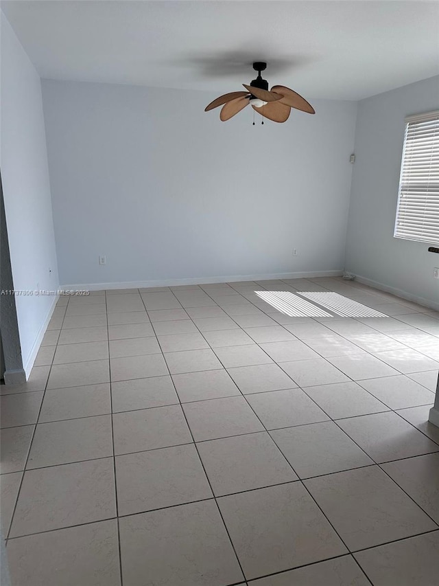 empty room featuring light tile patterned floors and ceiling fan