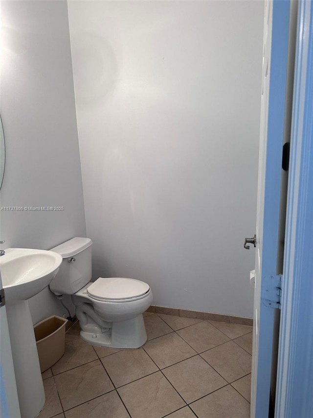 bathroom with tile patterned floors and toilet