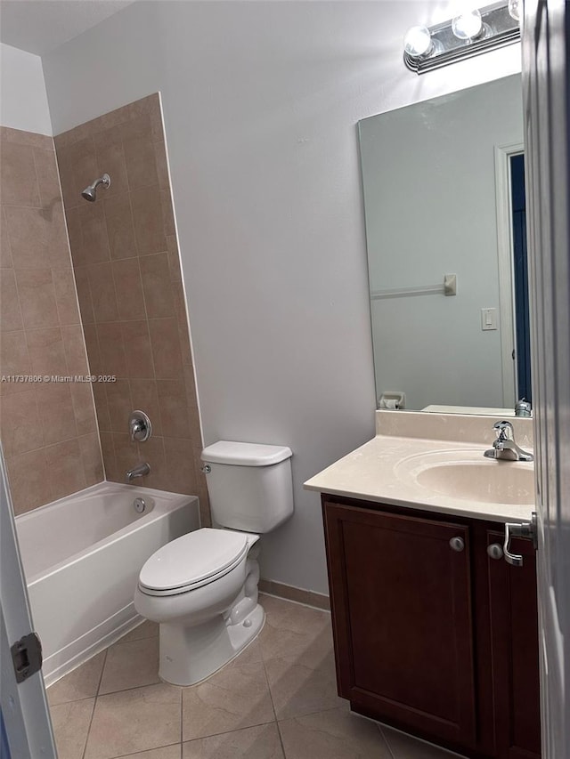 full bathroom featuring tile patterned flooring, vanity, tiled shower / bath combo, and toilet